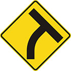 yellow diamond-shaped sign with black T shape which curves to the right at the stem