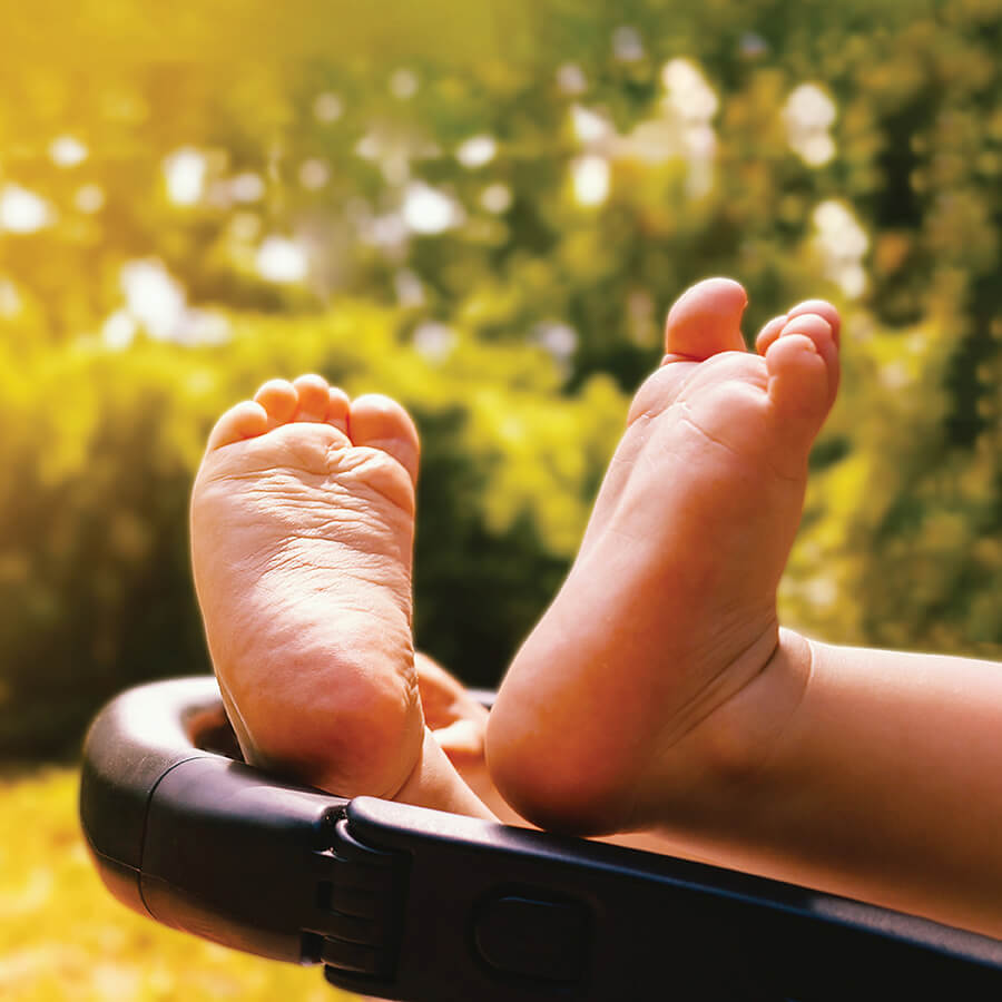 A baby's feet bask in the sunshine.